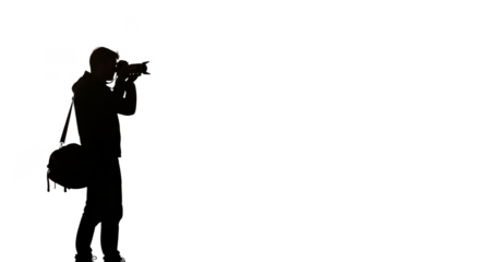 Silhouetted photographer with camera bag