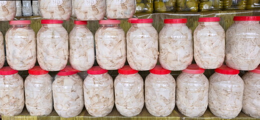 Sour bamboo shoots or preserved bamboo shoots stacked for saleare placed in a plastic jar and the...