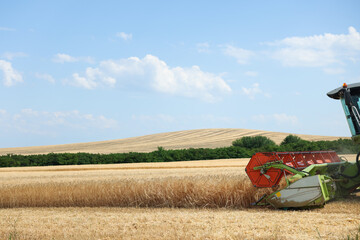 Modern combine harvester working in wheat field