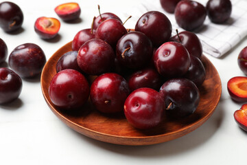 Ripe cherry plums on white table, closeup