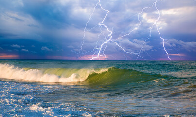 Tropical power sea wave under amazing storm clouds with lightning 