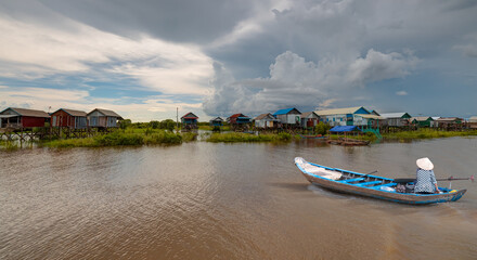 Fototapeta premium Tonle Sap lake, Siem reap Province, Cambodia. Fisherman in his boat, Floating village of Kompong Phluk, Cambodia.