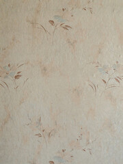Vintage wallpaper featuring a delicate floral pattern in soft, muted colors.