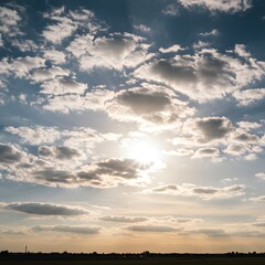 Obraz premium Atmospheric view of a brilliant sunburst breaking through dramatic clouds in a vast blue sky, a celestial background