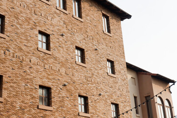 Modern Condominium and apartment building red brick wall in the city downtown,Residential Building on sky background.