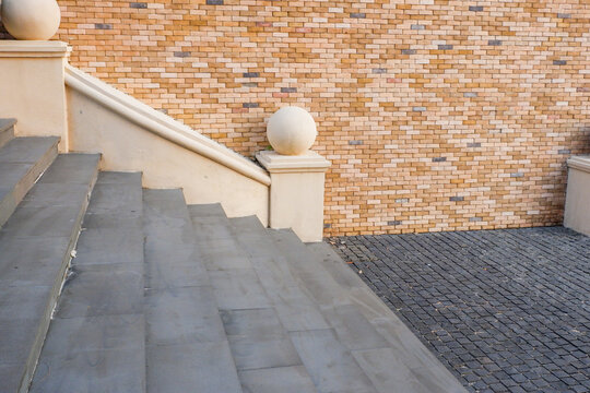 Stairs in the city,Granite stairs and red brick wall,Stone stairway Modern,concrete stairs outside,Empty modern building composition. - Powered by Adobe