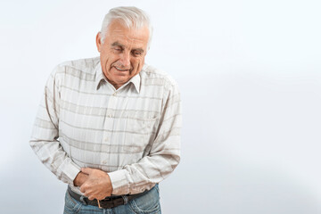 Mature man clutching his stomach. Symptoms of inflammation and pain in the intestines, liver, and...