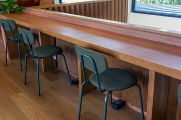 Modern table and chair set in home,indoor seating for restaurant or cafe, sitting area and view small garden in forest.