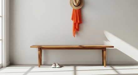 Wooden bench with straw hat and orange scarf hanging on white wall and white shoes on floor image