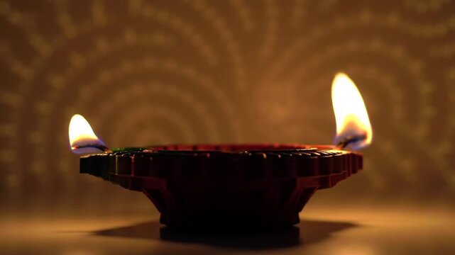 Two Flickering Flames on a Traditional Diwali Diya Lamp Illuminate a Warm Festive Background.