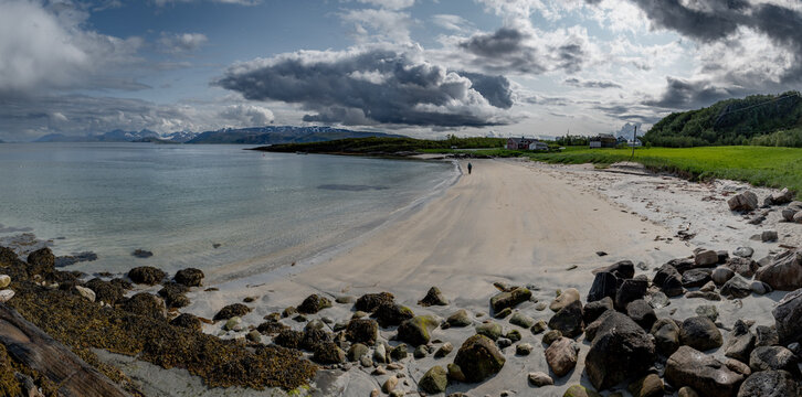 White Sand Beach With Red Cottage And Calm Fjord On Sommaroy Island In Norway