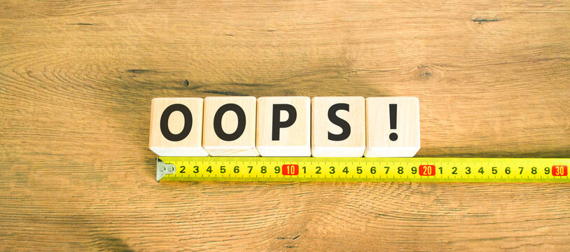 Oops symbol. Concept word Oops on beautiful wooden blocks. Beautiful wooden table wooden background. Beautiful yellow ruler. Business lifestyle oops concept. Copy space.