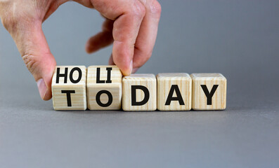 Today is holiday symbol. Concept word Today and Holiday on wooden cubes. Businessman hand. Beautiful grey table grey background. Business and today is holiday concept. Copy space.