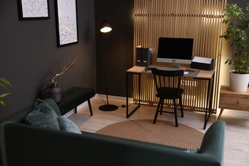 Stylish workplace with wooden desk and computer indoors