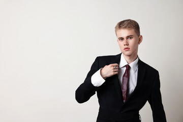 Handsome young man wearing stylish suit on white background, space for text