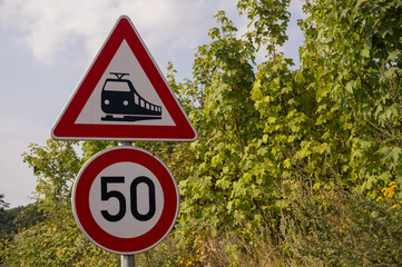 Warning signs showing railroad crossing and speed limit in borken, germany