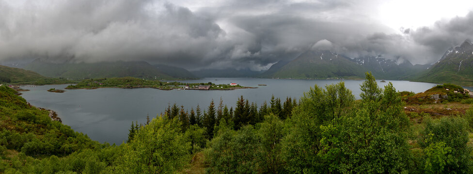 Rural Landscape With Remote Village, Calm Fjord And Foggy Mountains On Lofoten Islands In Norway