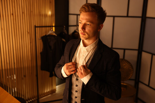 Man in stylish outfit getting ready indoors