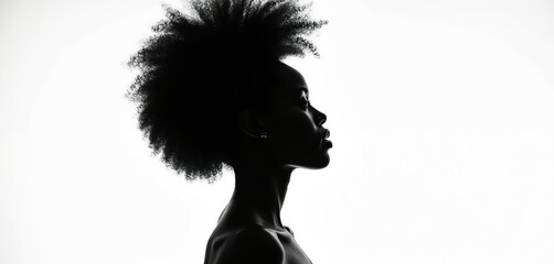 Profile silhouette of Black woman with voluminous afro hair against stark white background. Gaze directed forward, conveying strength, contemplation. Minimalist style emphasizes features, hair.