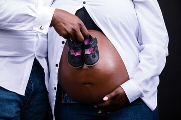 Couple babybump maternity pregnancy photoshoot baby shoes props details white shirt stomach
