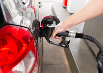 Man refueling car at gas station. Transportation and energy concept.