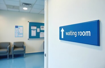 British hospital waiting room sign points towards empty clean corridor. Blue sign indicates waiting room. Modern chairs, information board visible in background. Focus on clean, minimalist medical