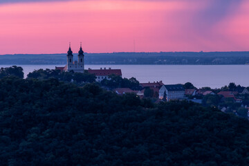 Baroque church at sunrise above lakeside village, panoramic view of Lake Balaton from the Tihany...