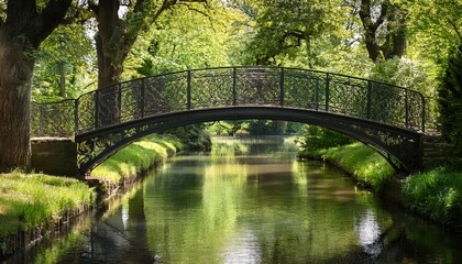 elegant wrought iron bridge spans calm park canal framed by greenery and old trees offering serene atmosphere in spring sunlight