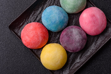 Japanese mochi, ice cream or Asian sweets with fruit filling. Mochi of different colors