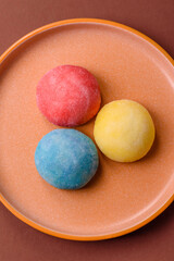 Japanese mochi, ice cream or Asian sweets with fruit filling. Mochi of different colors