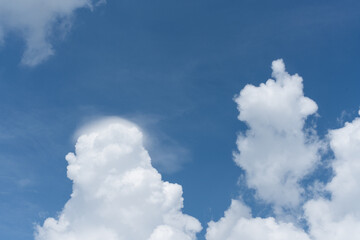 huge cumulus clouds in the blue sky