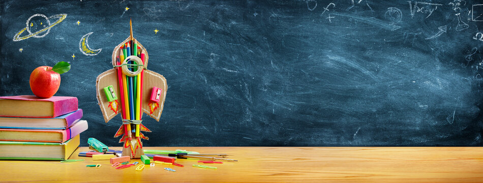 Start School Concept - Rocket And Stationery On Desk With Drawn On Blackboard