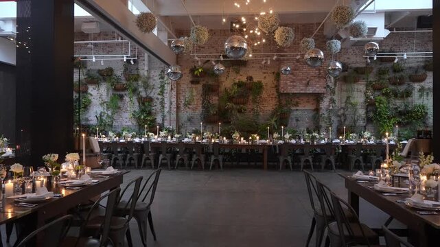 The event space is beautifully arranged with floral centerpieces and soft lighting for a warm ambiance