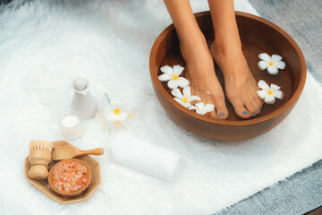 Panorama top view woman indulges in blissful foot massage at luxurious spa salon while masseur give...