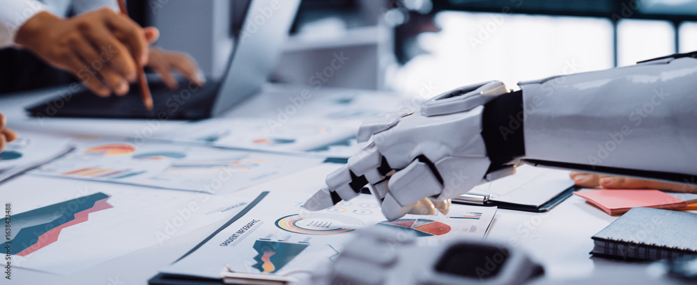 Poster a robot arm collaborates with a human in a modern office, analyzing various graphs and data on a des