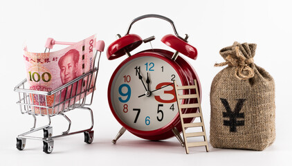 100 Chinese Yuan banknote and alarm clock on white background