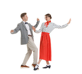Happy couple in retro outfits dancing on white background
