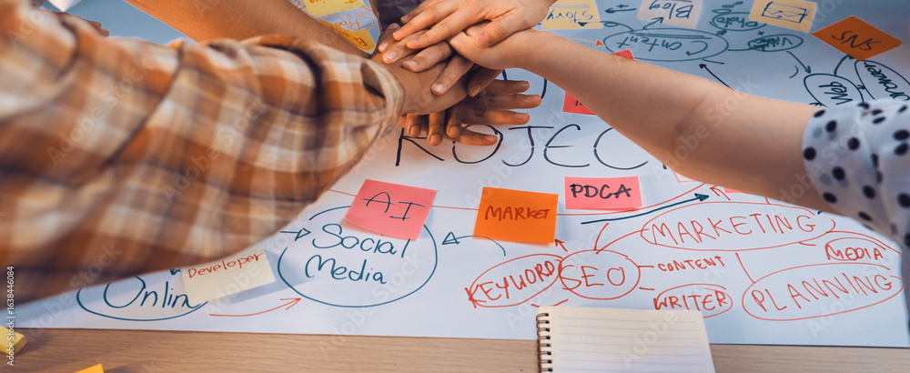 Aufkleber enthusiastic teamwork is depicted as diverse hands unite over a detailed brainstorming sheet filled 