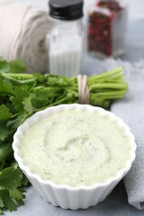 Tasty cilantro sauce in bowl on grey table, closeup