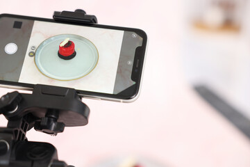 Shooting tasty dessert with smartphone in studio, selective focus. Professional food photography