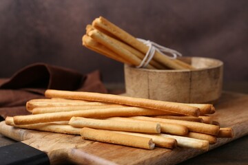 Delicious grissini sticks on wooden table, closeup