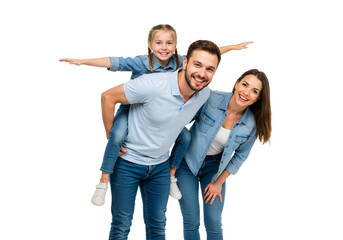 Happy young family in denim clothes posing together, with the joyful daughter getting a piggyback ride from her smiling father.