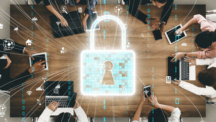 A modern workspace highlights teamwork and cyber security, featuring digital lock icons and technology overlays. Ideal for depicting data protection and privacy. Xenic