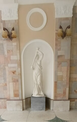 A headless marble figure freezes in graceful motion, echoing ancient elegance