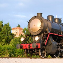 Fototapeta premium Steam Train Journey Through Picturesque Countryside With Distant Castle View