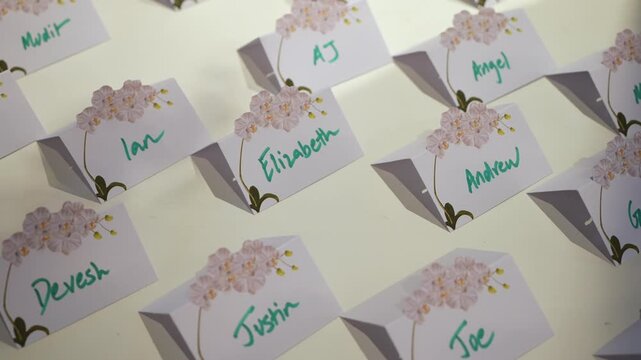 The designed name cards create perfect seating arrangements at events, featuring lovely floral elements