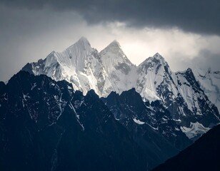 Obraz premium Snowy peaks pierce dark mountain range