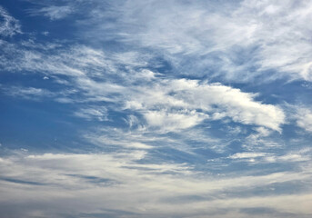 Blue Sky with White Fluffy Clouds. Natural Background for Weather, Nature, and Travel Concepts. High resolution sky texture wallpaper. Clear sunny morning sky.
