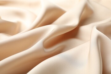 Crumpled beige silk fabric as background, closeup
