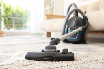 One vacuum cleaner on floor indoors, closeup. Household appliance